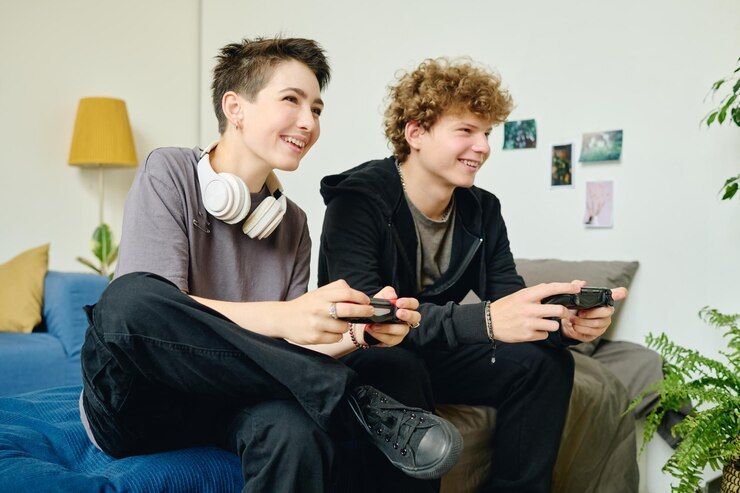cheerful-teenage-friends-dates-with-gamepads-playing-video-games_274679-45392.jpg