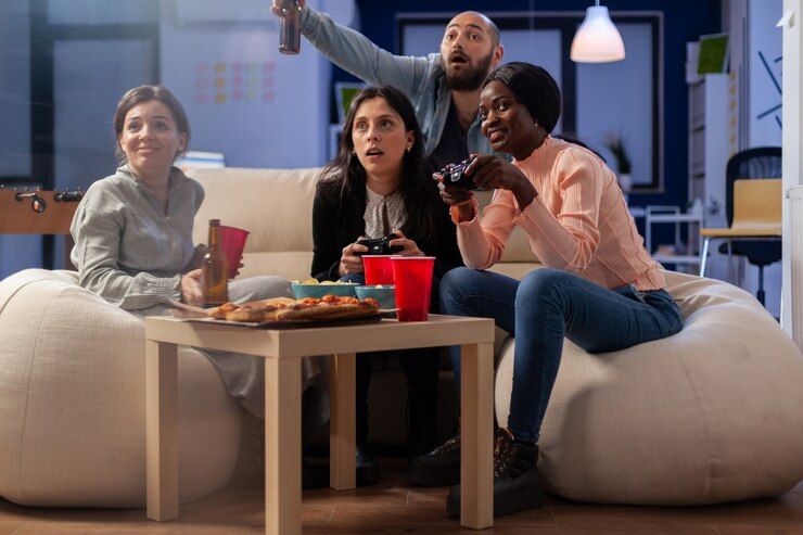 happy-people-enjoying-game-console-after-work-office-while-using-controller-joystick-multi-ethnic-group-workers-play-fun-entertainment-party-celebration-indoors_482257-15022 (1).jpg